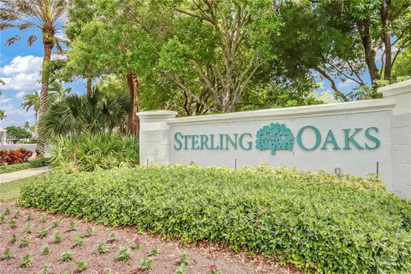 a sign broad in front of flowers