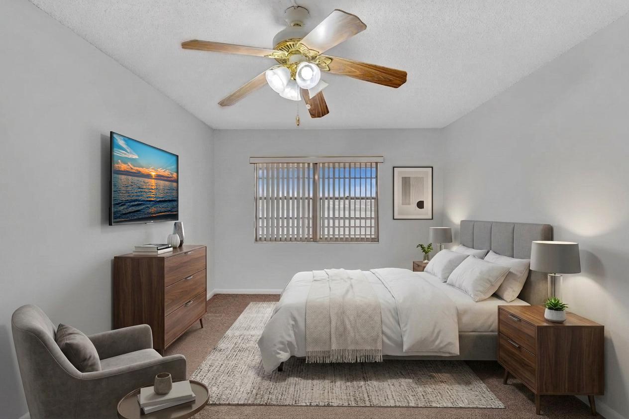 2066 Exeter Boca Raton, FL 33434 - Photo 19 of 60 a spacious bedroom with a bed and a flat screen tv
