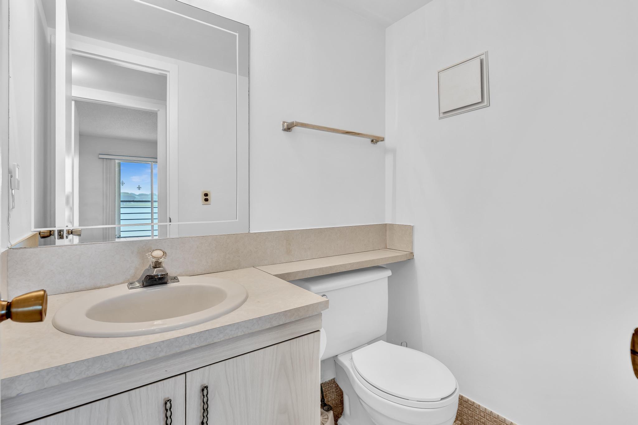 2066 Exeter Boca Raton, FL 33434 - Photo 22 of 60 a bathroom with a sink a toilet and a mirror