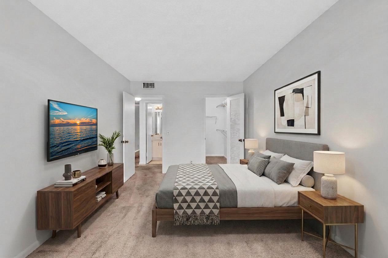 2066 Exeter Boca Raton, FL 33434 - Photo 25 of 60 a spacious bedroom with a bed and a flat screen tv