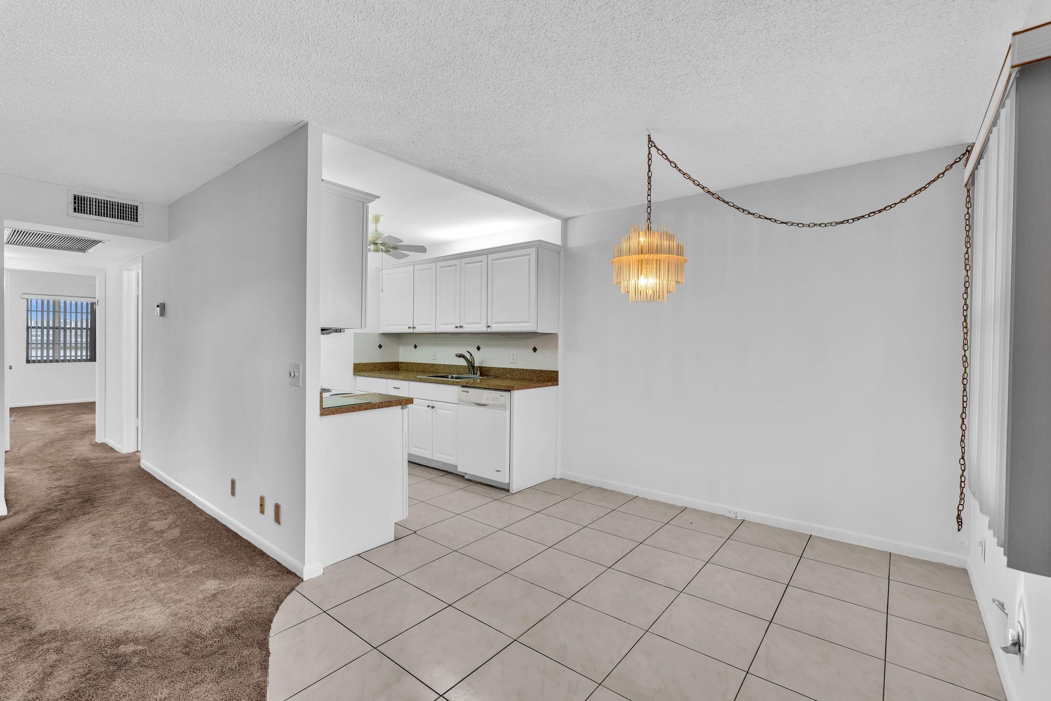 2066 Exeter Boca Raton, FL 33434 - Photo 8 of 60 a kitchen with white cabinets and window