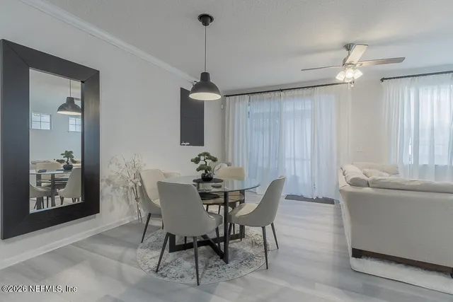 a view of a dining room with furniture and chandelier