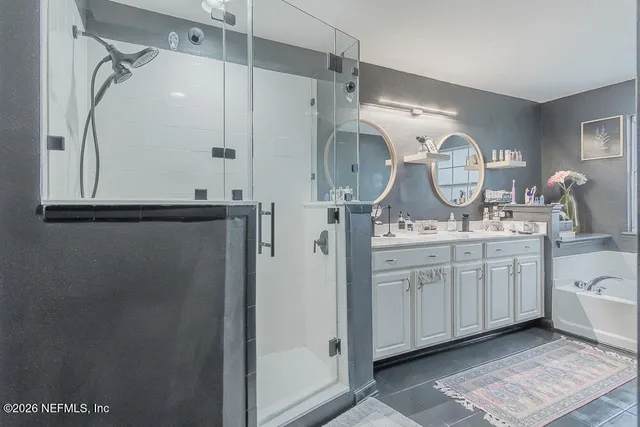 a bathroom with a double vanity sink and a mirror