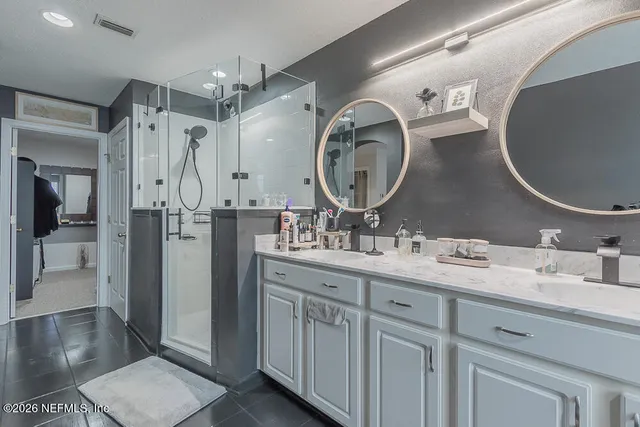 a bathroom with a shower and a glass door