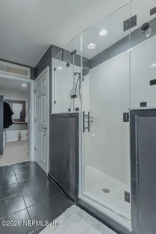 a view of walk in closet with clothes