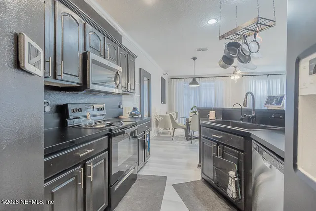 a kitchen with stainless steel appliances granite countertop a stove and a sink