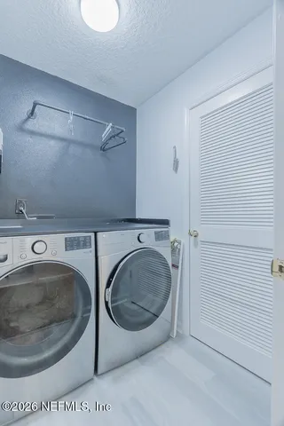 a bedroom with furniture and a chandelier fan
