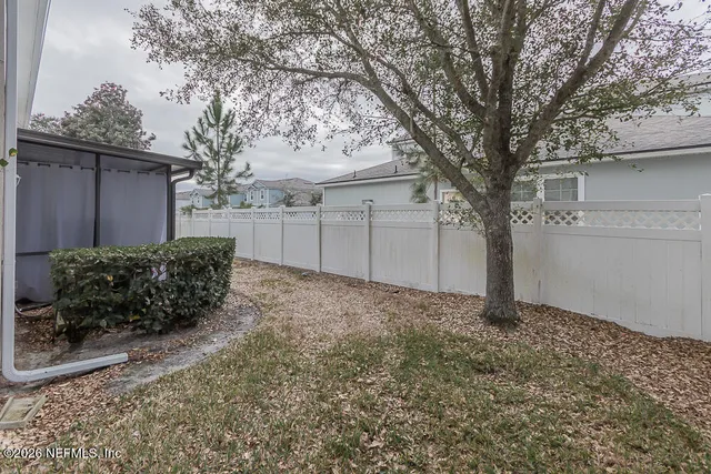 a view of a house with a large window and garage