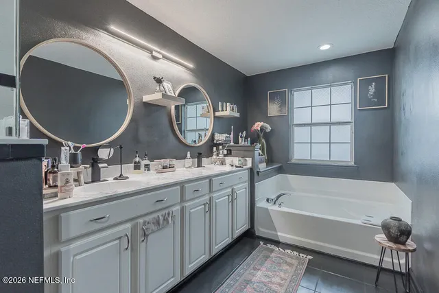 a bathroom with a double vanity sink and a mirror