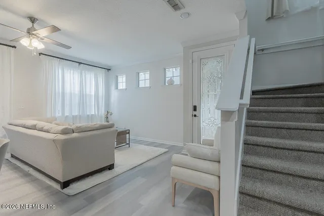 a living room with furniture and a chandelier