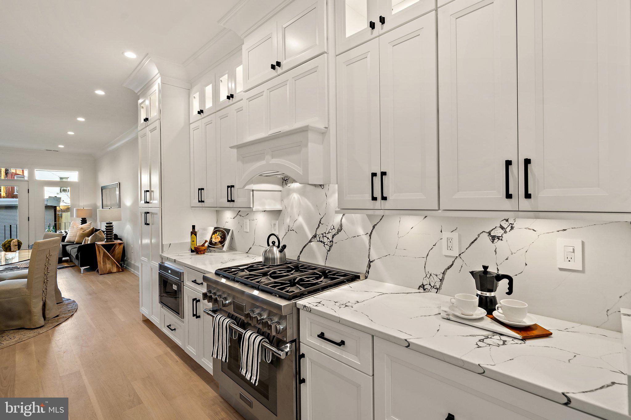 634 F Street Northeast Washington, DC 20002 - Photo 10 of 57 a kitchen with a stove and cabinets