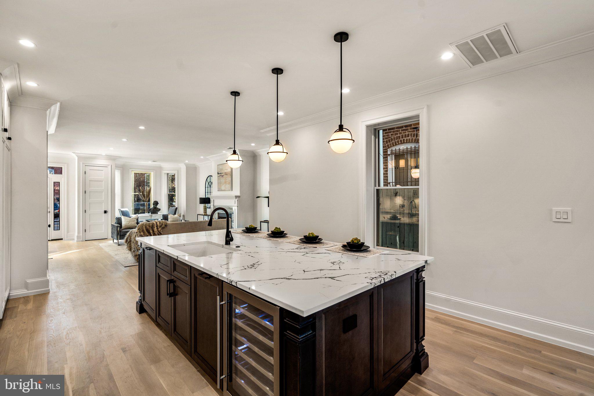 634 F Street Northeast Washington, DC 20002 - Photo 11 of 57 a view of kitchen island a sink and wooden floor