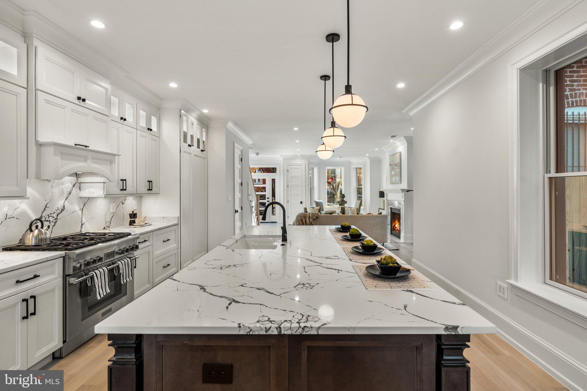 634 F Street Northeast Washington, DC 20002 - Photo 13 of 57 a kitchen with stainless steel appliances granite countertop a sink a stove and refrigerator