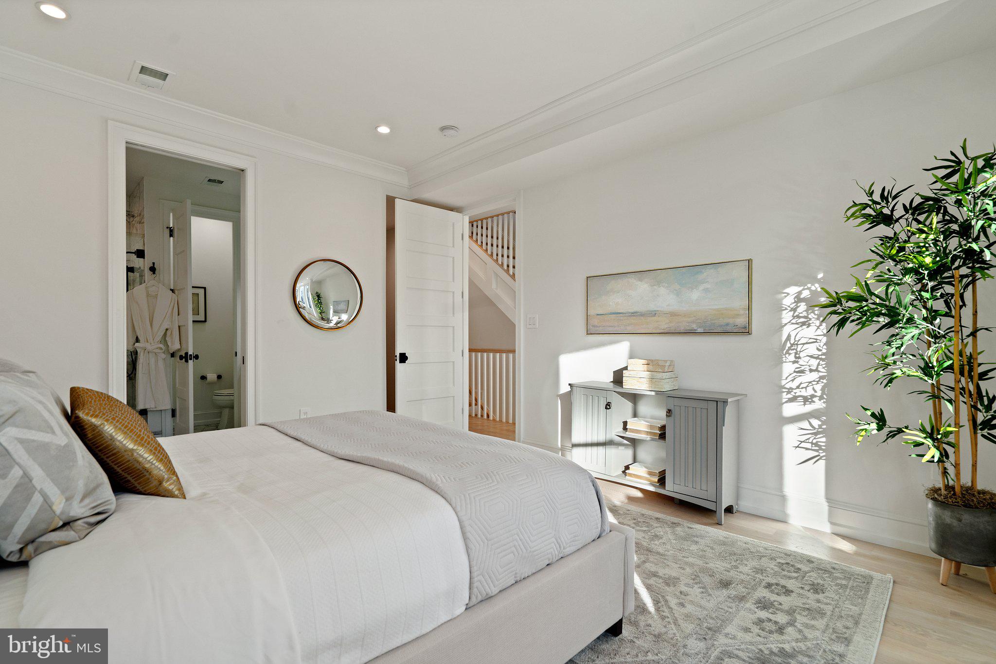 634 F Street Northeast Washington, DC 20002 - Photo 26 of 57 a bedroom with a large bed and a chandelier