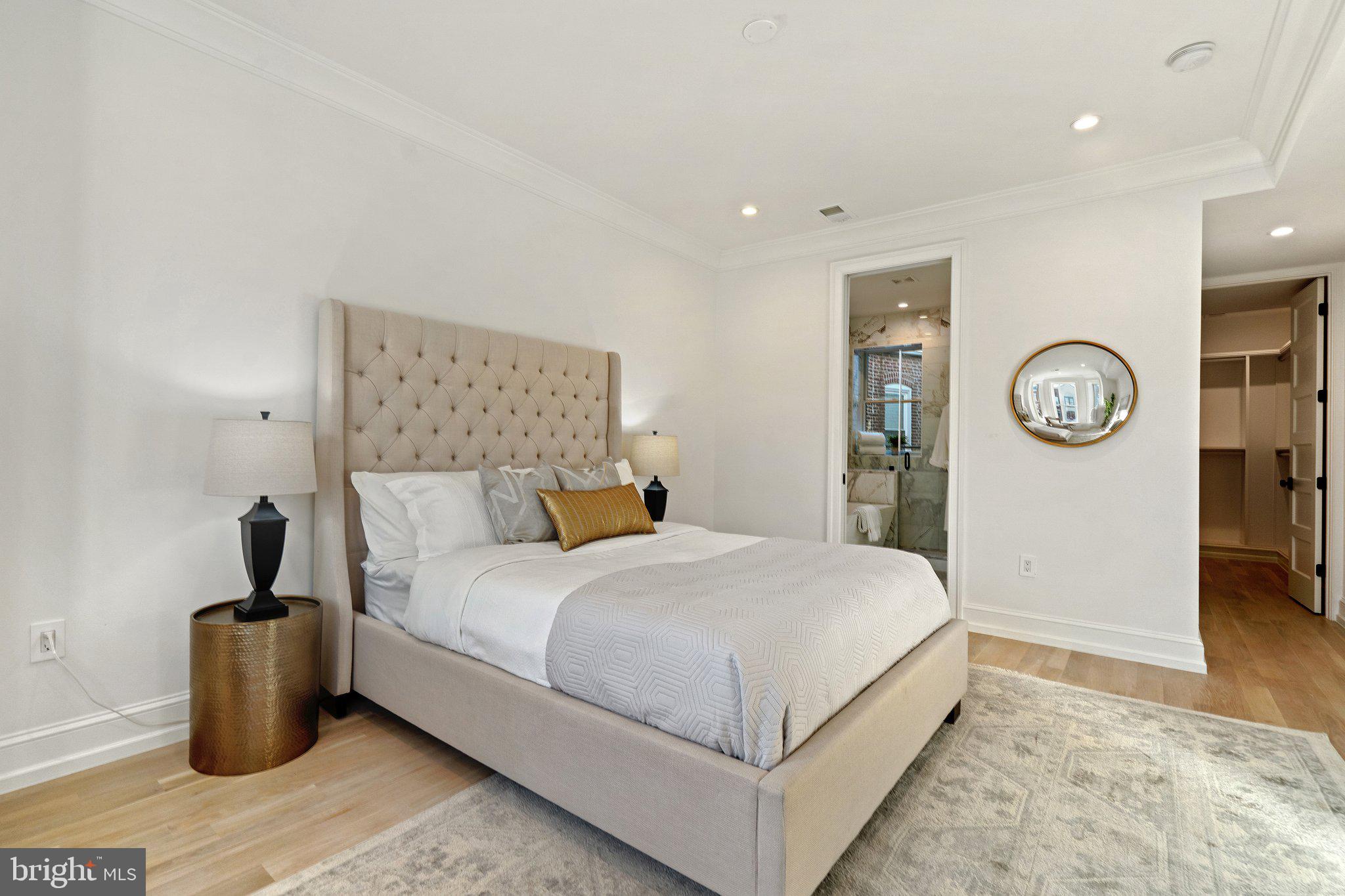 634 F Street Northeast Washington, DC 20002 - Photo 27 of 57 a large bedroom with a bed and painting on the wall