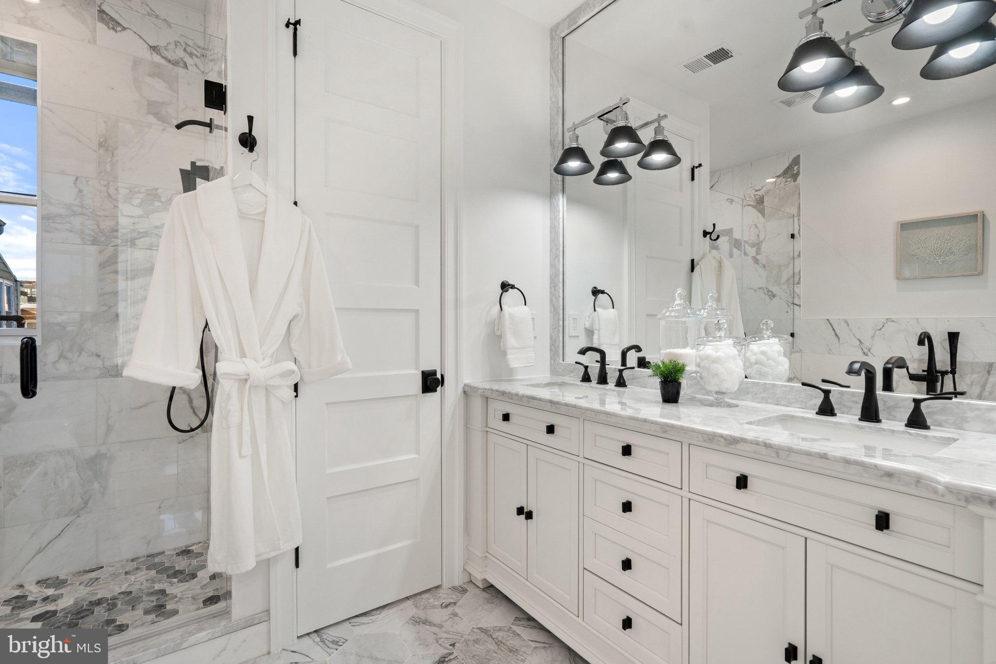 634 F Street Northeast Washington, DC 20002 - Photo 29 of 57 a bathroom with a double vanity sink mirror and shower