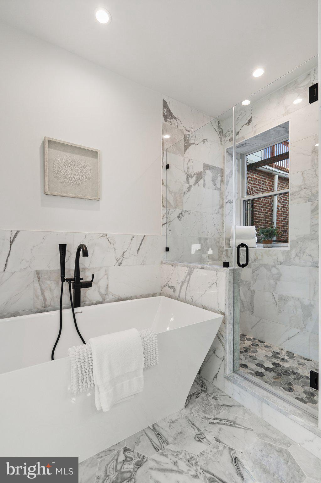 634 F Street Northeast Washington, DC 20002 - Photo 30 of 57 a bathroom with a bathtub and a shower