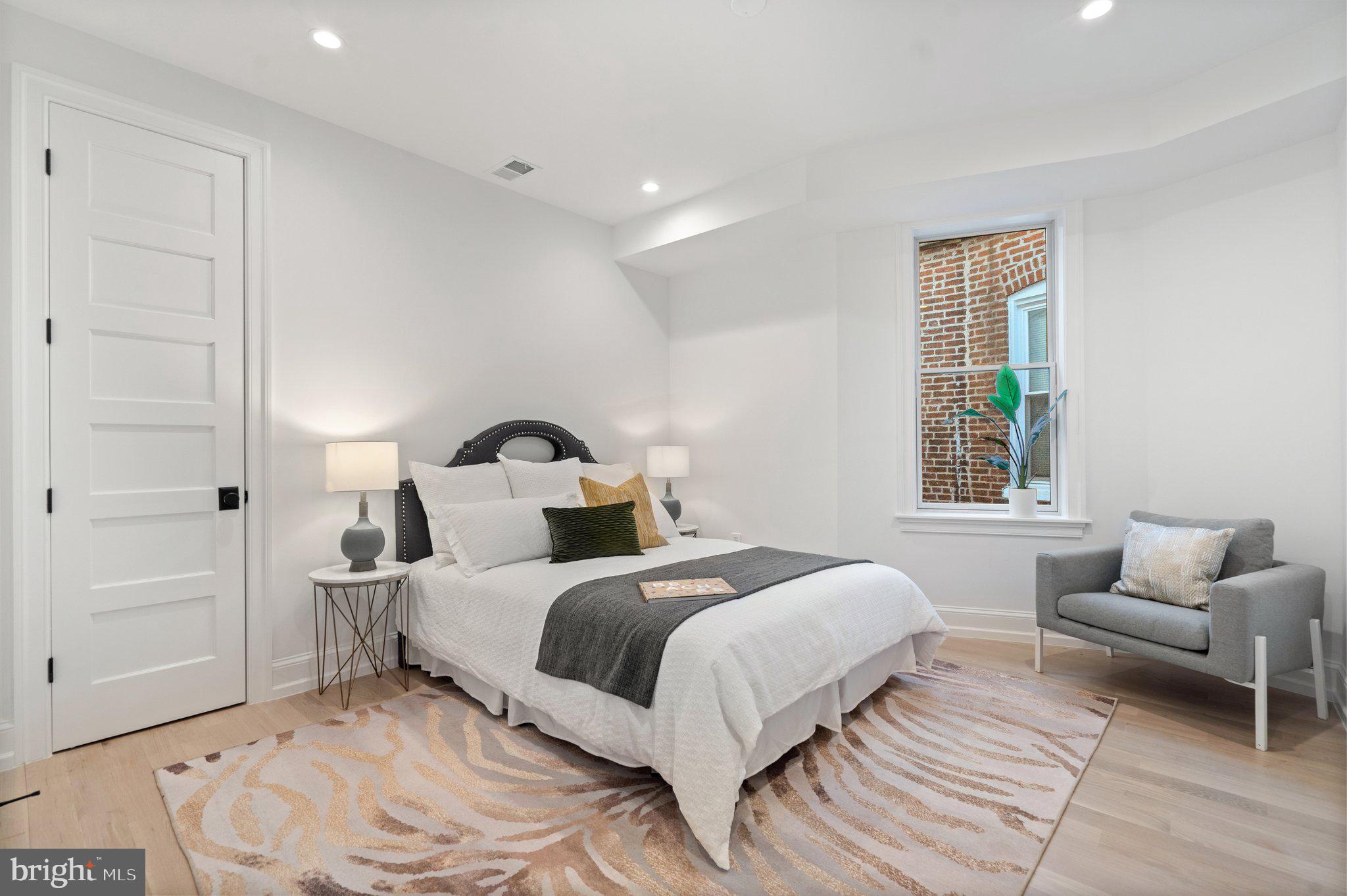 634 F Street Northeast Washington, DC 20002 - Photo 31 of 57 a bedroom with a bed and wooden floor