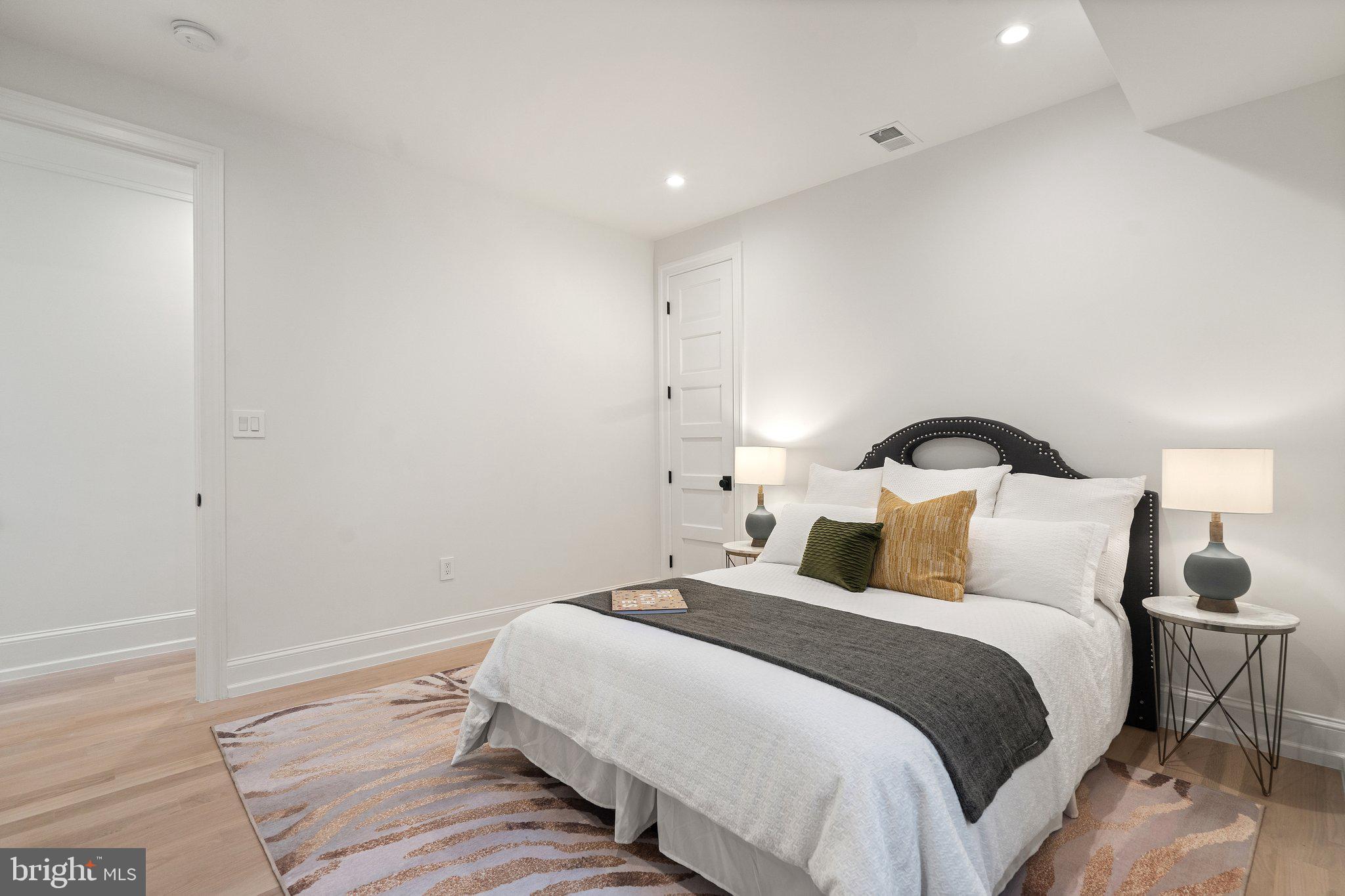 634 F Street Northeast Washington, DC 20002 - Photo 32 of 57 a bedroom with a bed and a lamp on table