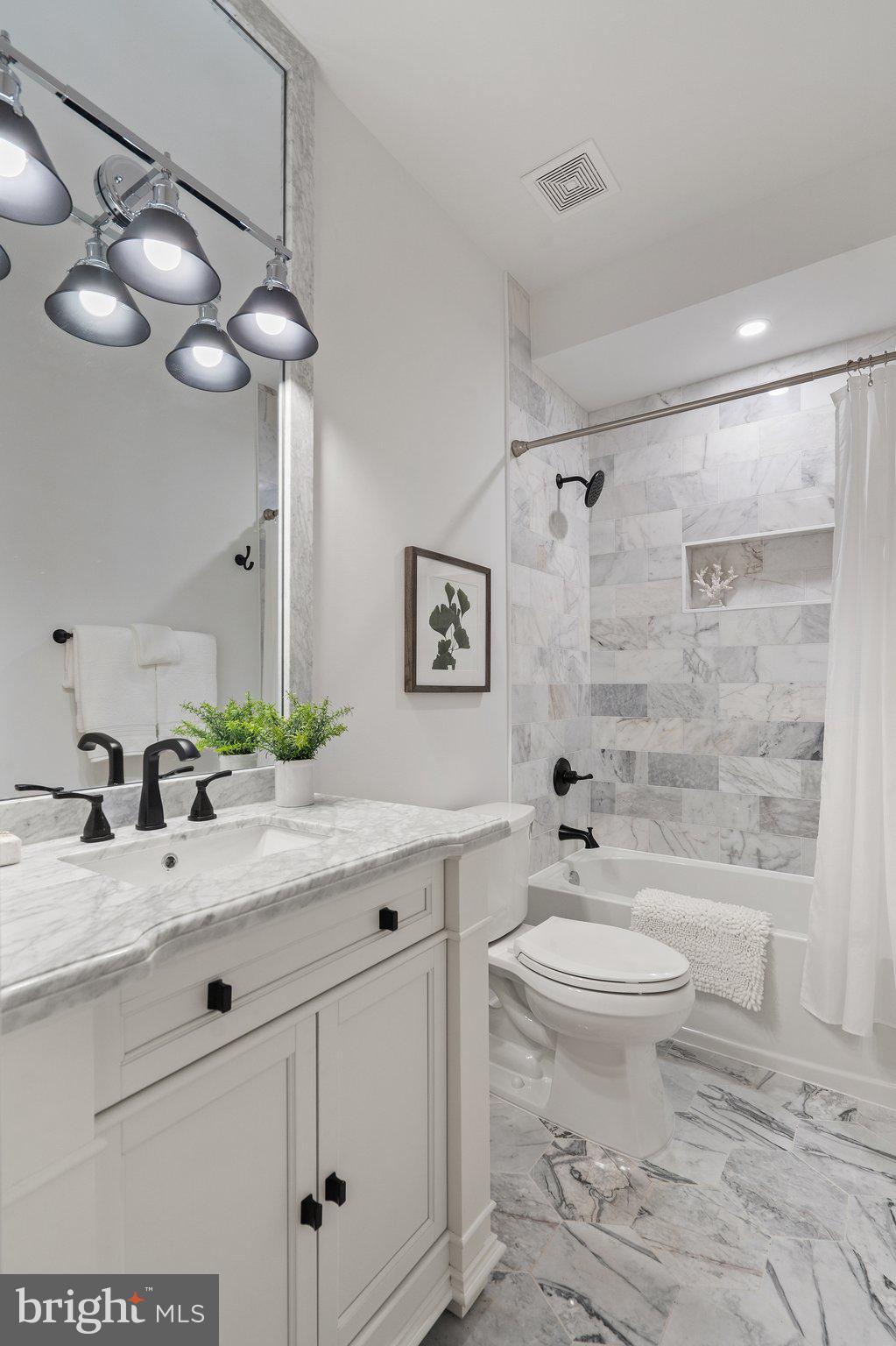 634 F Street Northeast Washington, DC 20002 - Photo 34 of 57 a bathroom with a sink a toilet and a mirror
