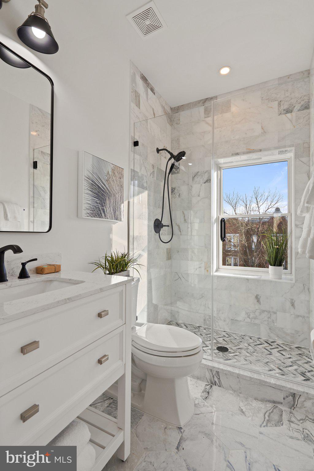 634 F Street Northeast Washington, DC 20002 - Photo 43 of 57 a bathroom with a toilet sink and mirror