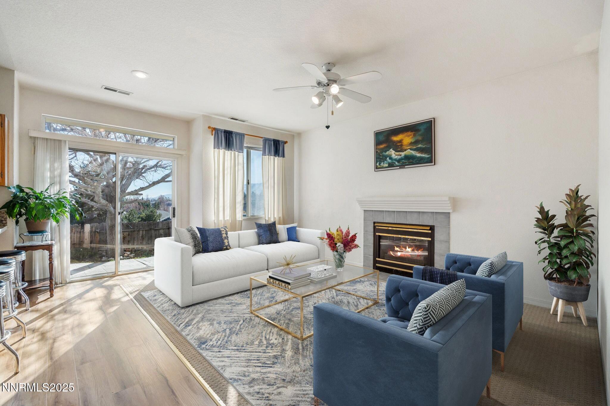 3952 Regal Drive Reno, NV 89503 - Photo 7 of 16 a living room with furniture a fireplace and a potted plant