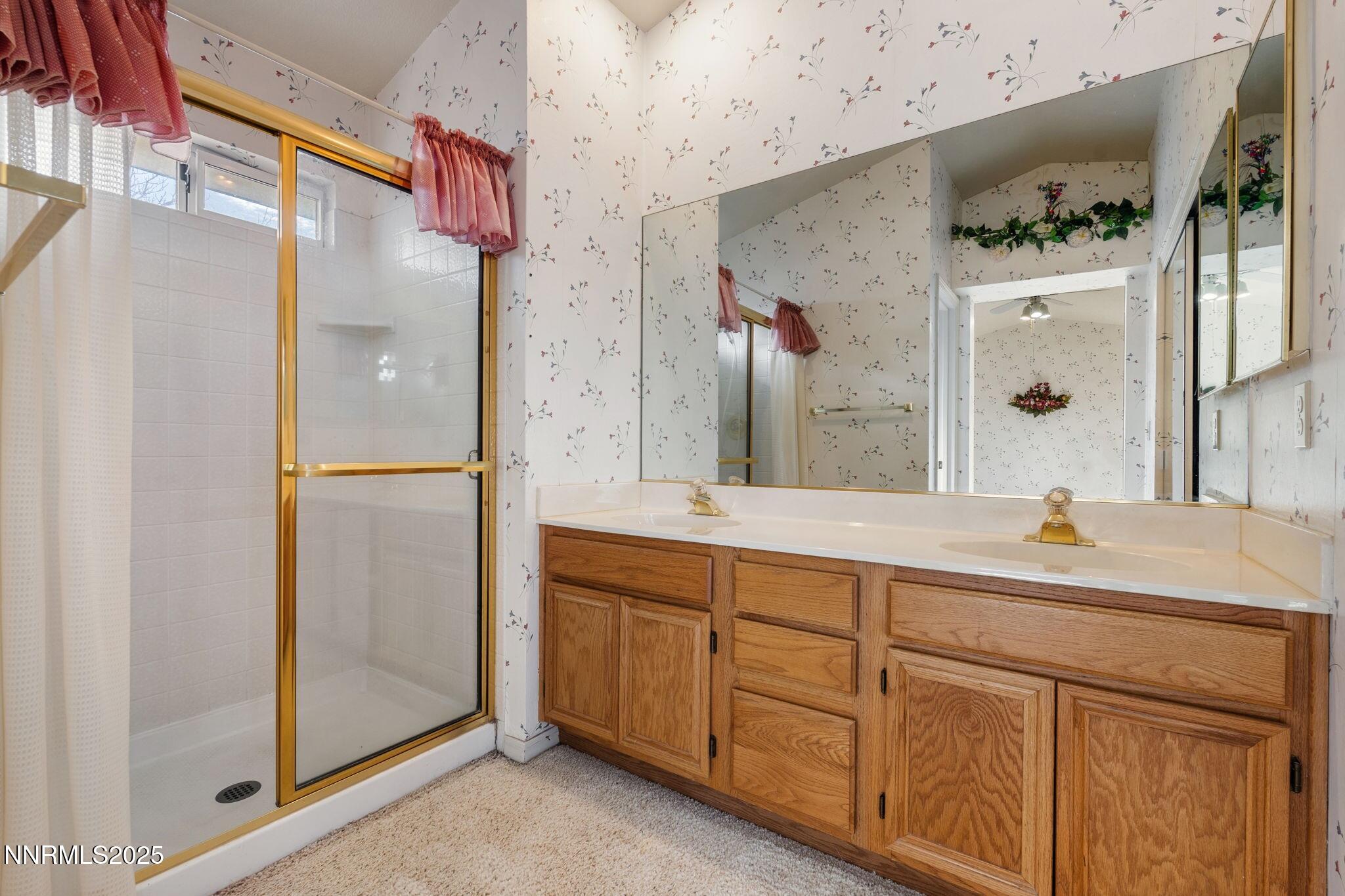 3952 Regal Drive Reno, NV 89503 - Photo 9 of 16 a bathroom with a double vanity sink and mirror