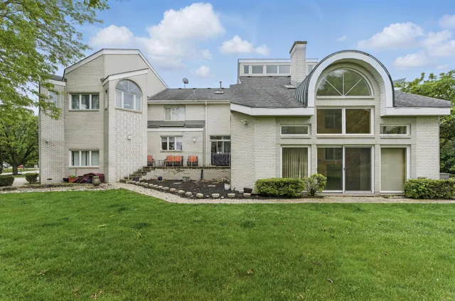 an aerial view of residential houses with outdoor space and trees