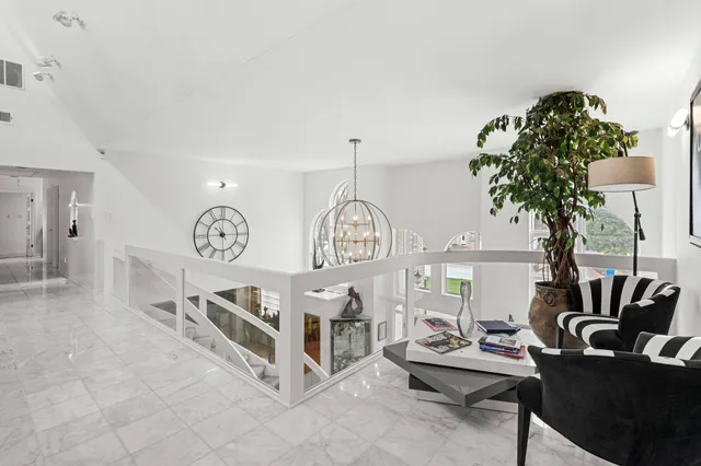 a kitchen with granite countertop a refrigerator a sink a stove a microwave and wooden cabinets