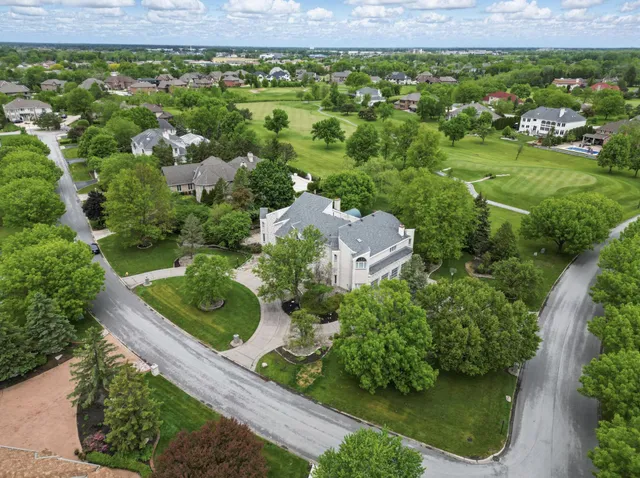 a living room with stainless steel appliances furniture and a wooden floor