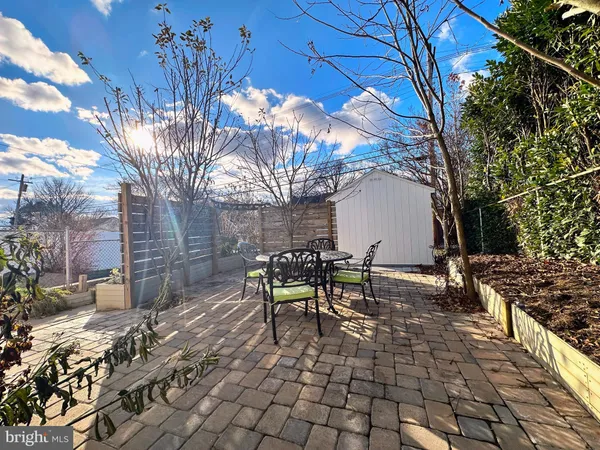 a view of a chairs and table in the backyard