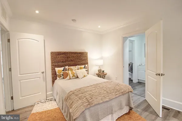 a bedroom with a bed and a dresser