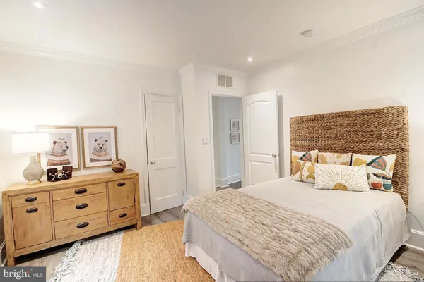 a bedroom with bed chair and window