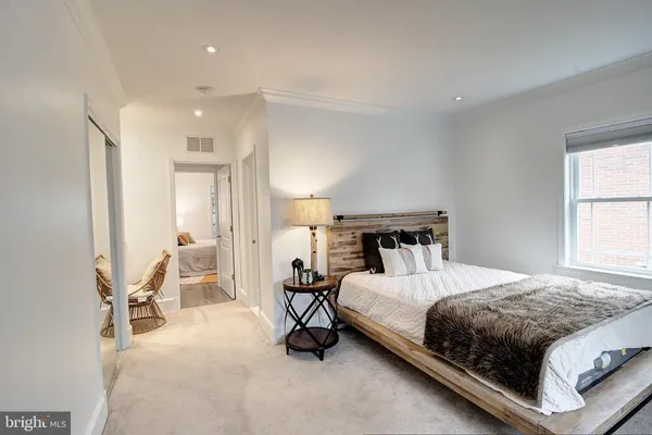 a bed room with a bed and a chair