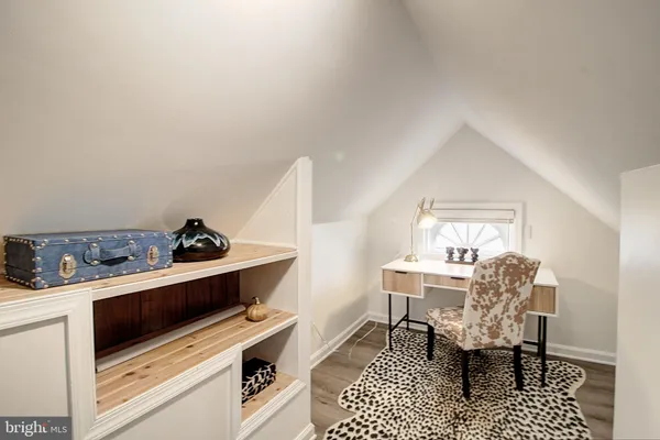 a kitchen with a refrigerator a stove and a dining table