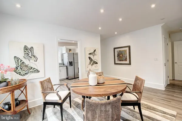 a dining room with furniture and wooden floor