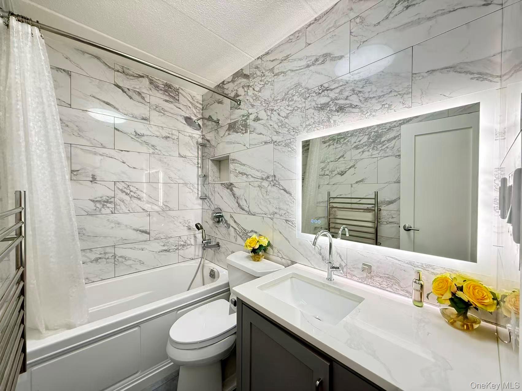 42-42 Union Street, Unit 9PHC Queens, NY 11355 - Photo 11 of 21 a bathroom with a granite countertop sink a toilet and a mirror