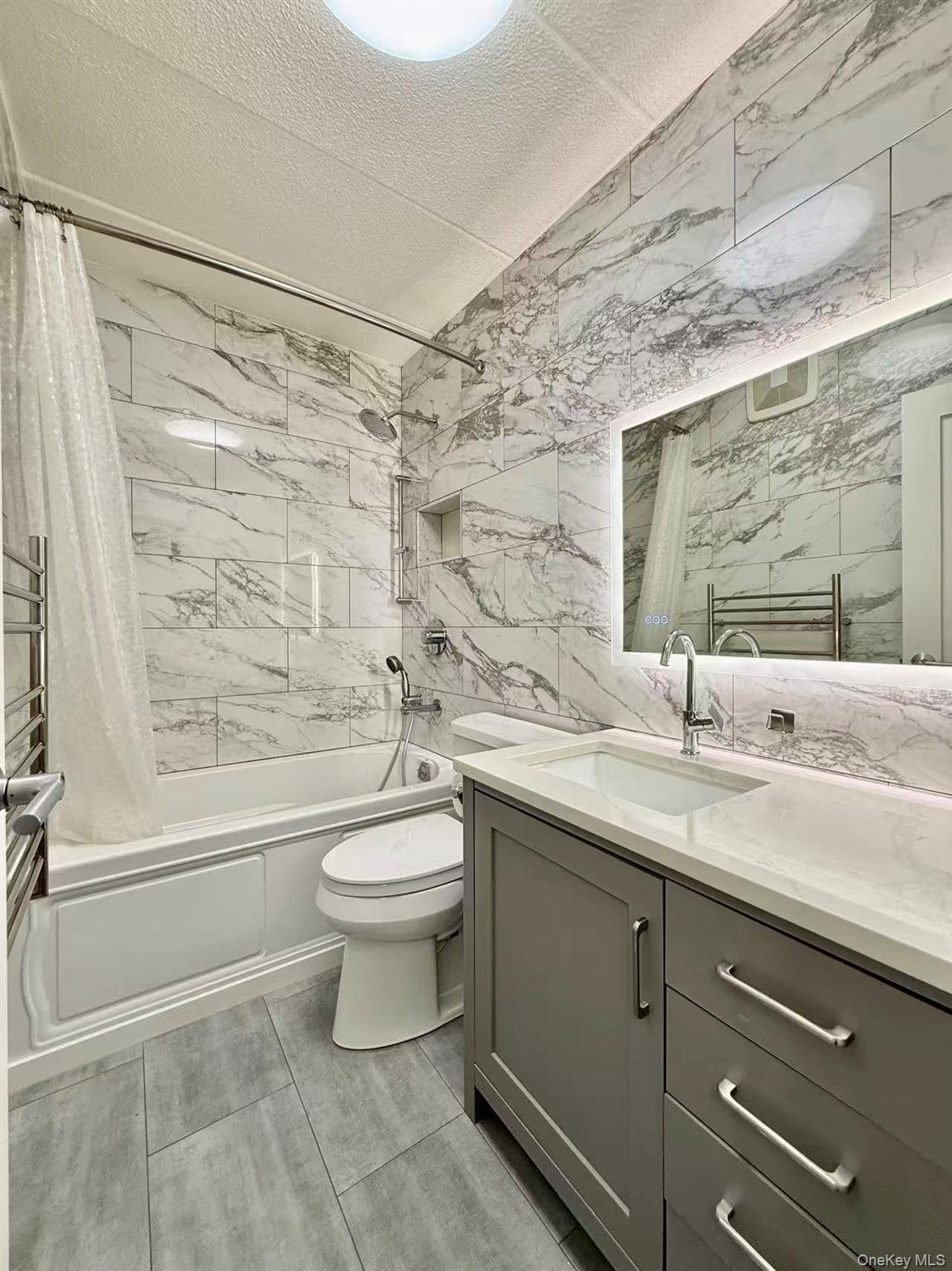 42-42 Union Street, Unit 9PHC Queens, NY 11355 - Photo 12 of 21 a bathroom with a granite countertop sink toilet and shower