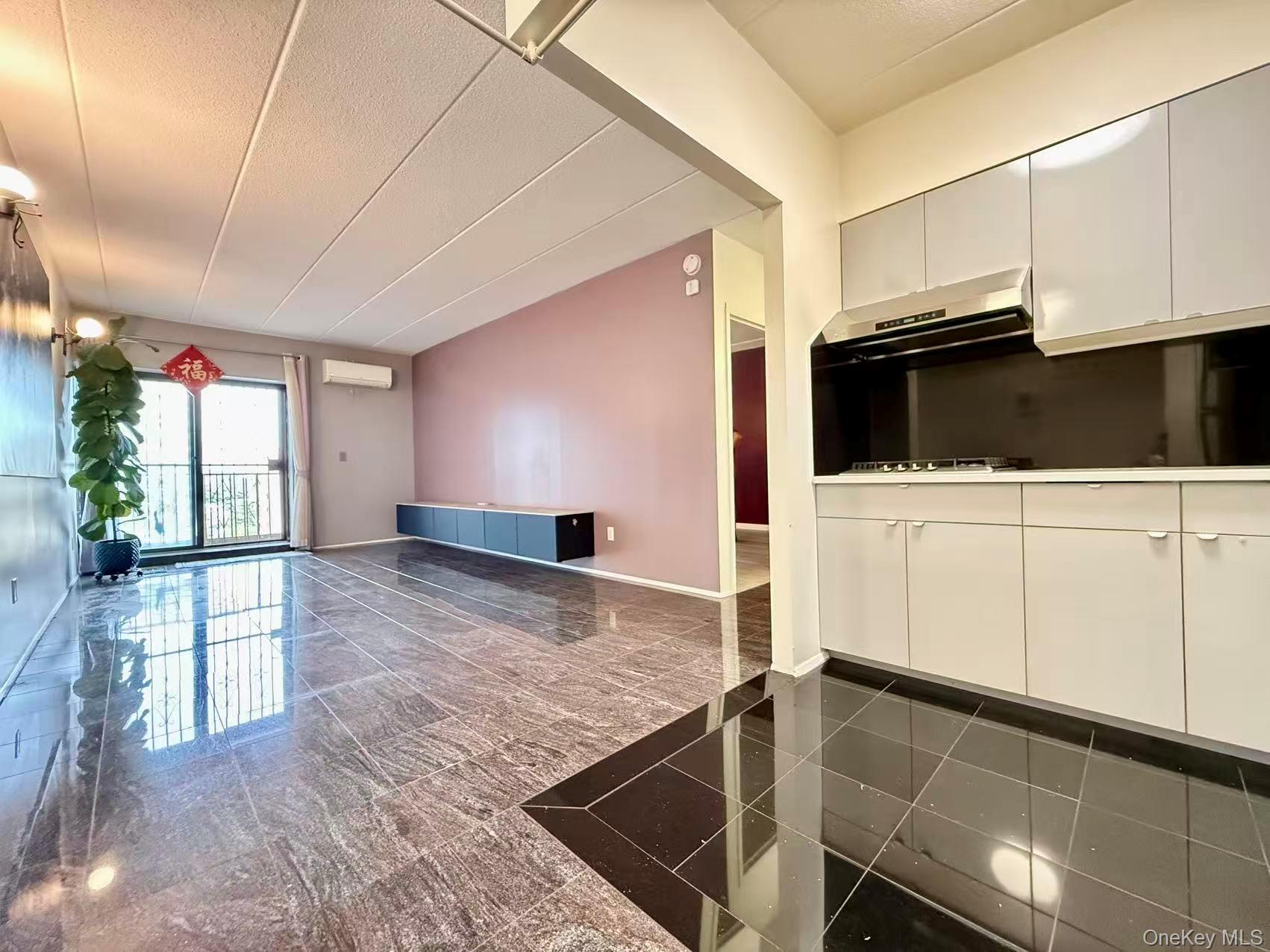 42-42 Union Street, Unit 9PHC Queens, NY 11355 - Photo 20 of 21 a kitchen with stainless steel appliances kitchen island granite countertop a stove and a sink