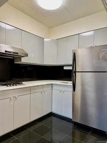 a kitchen with stainless steel appliances kitchen island granite countertop a stove and a sink