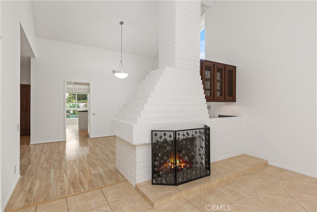 37 Beachcomber Drive Corona del Mar, CA 92625 - Photo 11 of 39 a view of a hallway with wooden floor and a kitchen