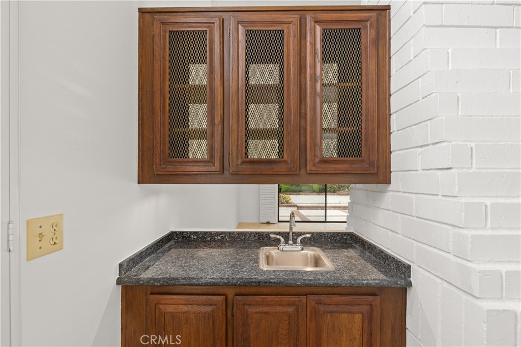 37 Beachcomber Drive Corona del Mar, CA 92625 - Photo 15 of 39 a bathroom with a granite countertop sink and a window