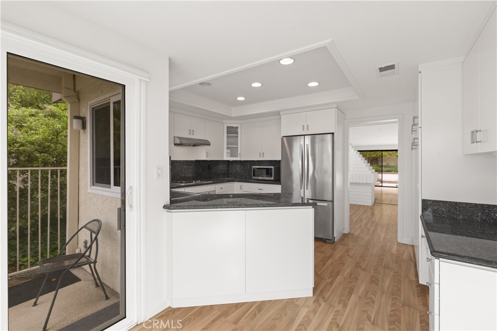 37 Beachcomber Drive Corona del Mar, CA 92625 - Photo 16 of 39 a kitchen with stainless steel appliances granite countertop a refrigerator and a stove top oven