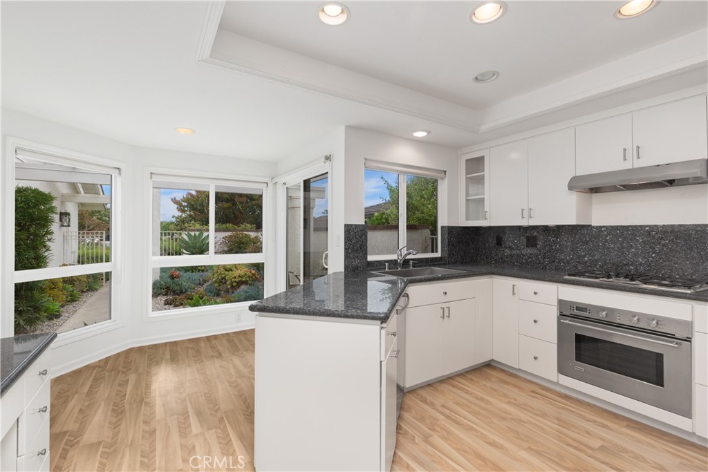 37 Beachcomber Drive Corona del Mar, CA 92625 - Photo 17 of 39 a large kitchen with granite countertop a stove and a sink