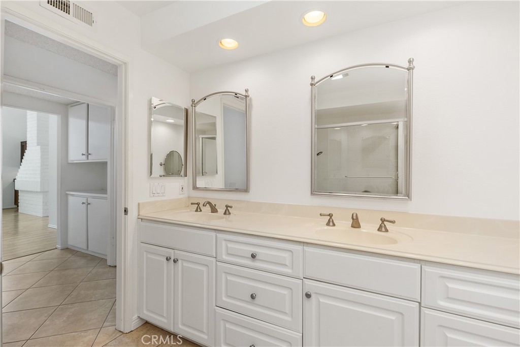 37 Beachcomber Drive Corona del Mar, CA 92625 - Photo 27 of 39 a bathroom with double vanity sinks and a mirror