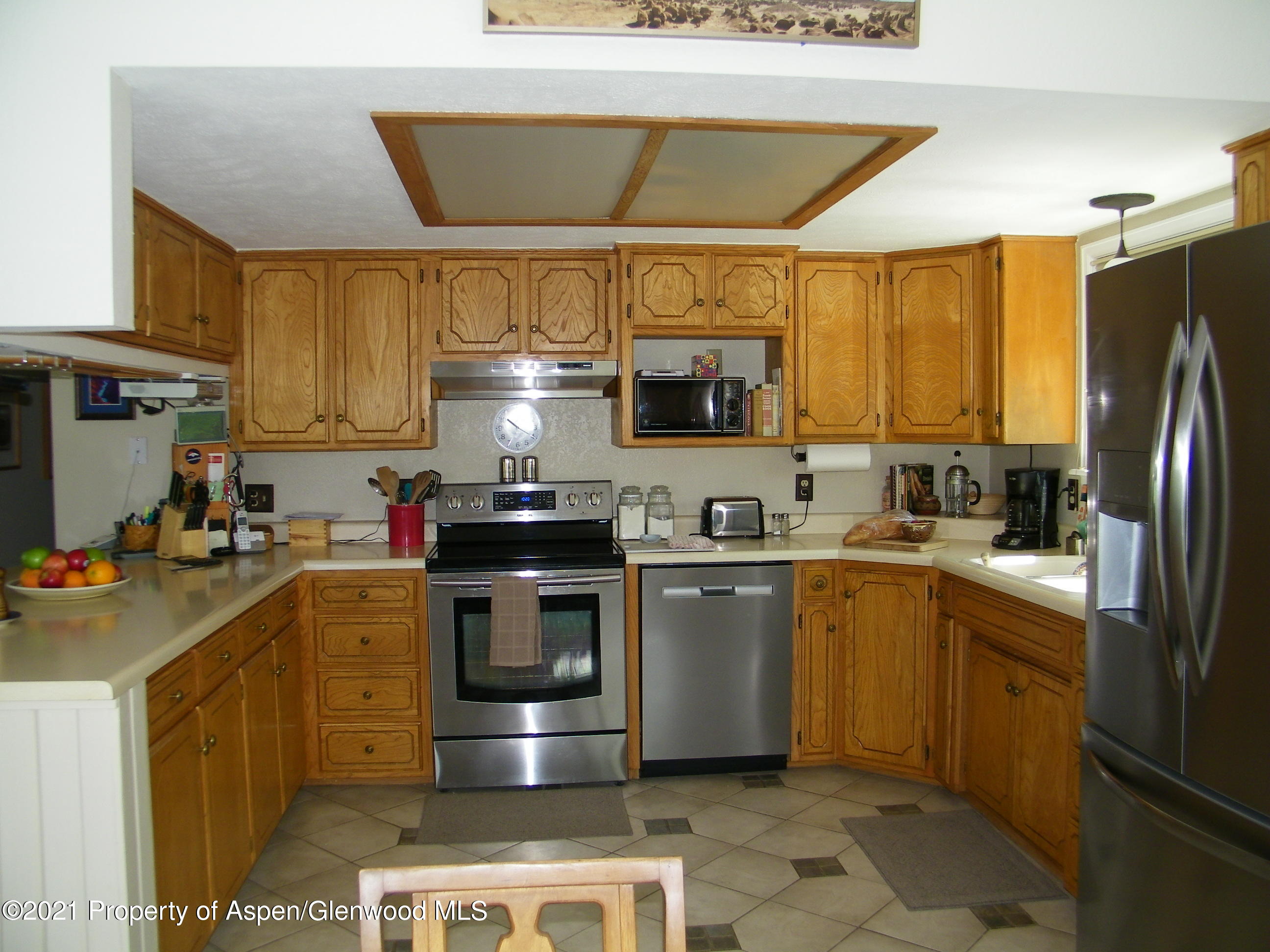 680 Moki Avenue Rifle, CO 81650 - Photo 24 of 39 a kitchen with a sink a stove and refrigerator