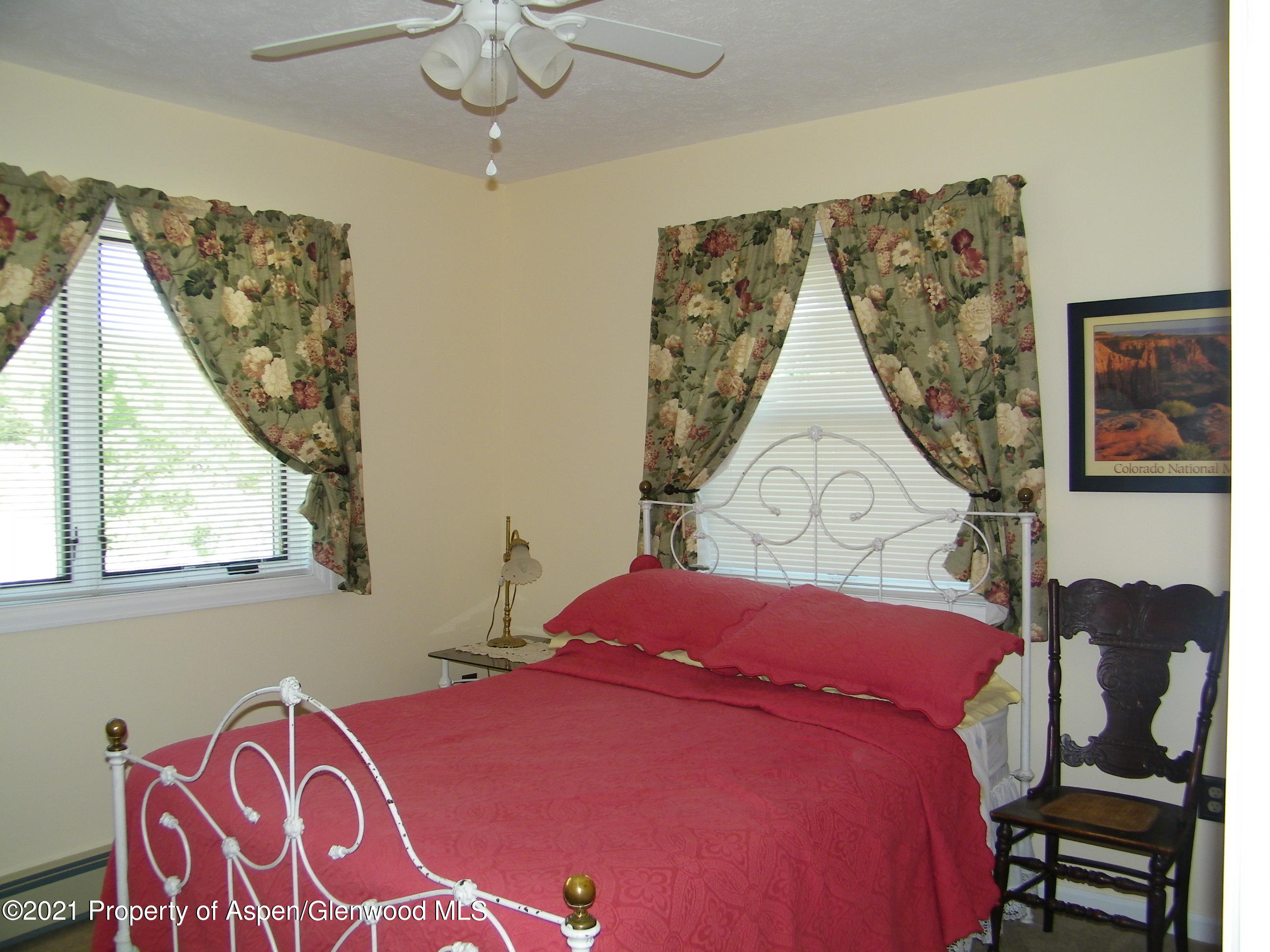 680 Moki Avenue Rifle, CO 81650 - Photo 29 of 39 a bedroom with a bed and wooden floor