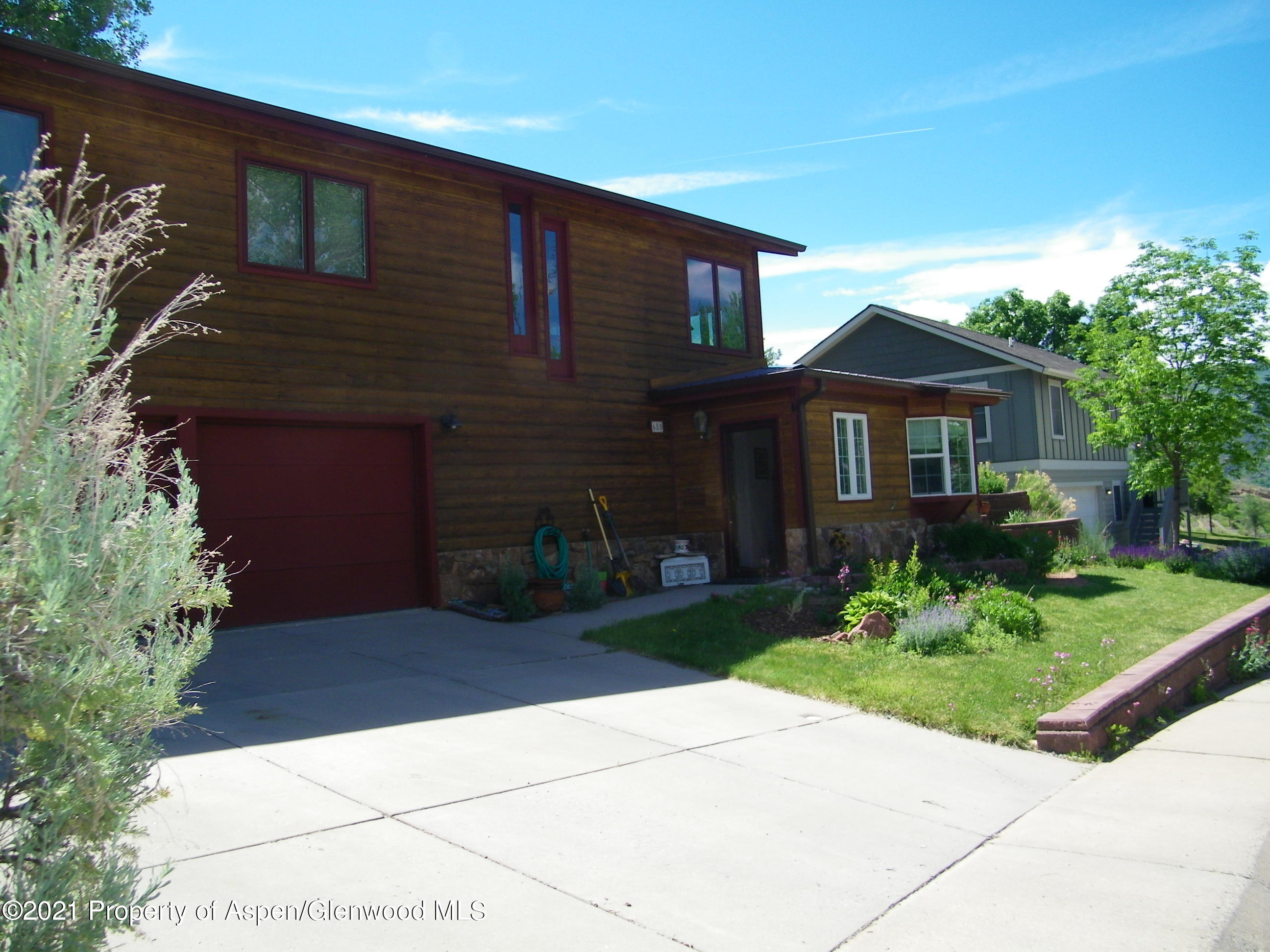 680 Moki Avenue Rifle, CO 81650 - Photo 3 of 39 a front view of a house with a garden