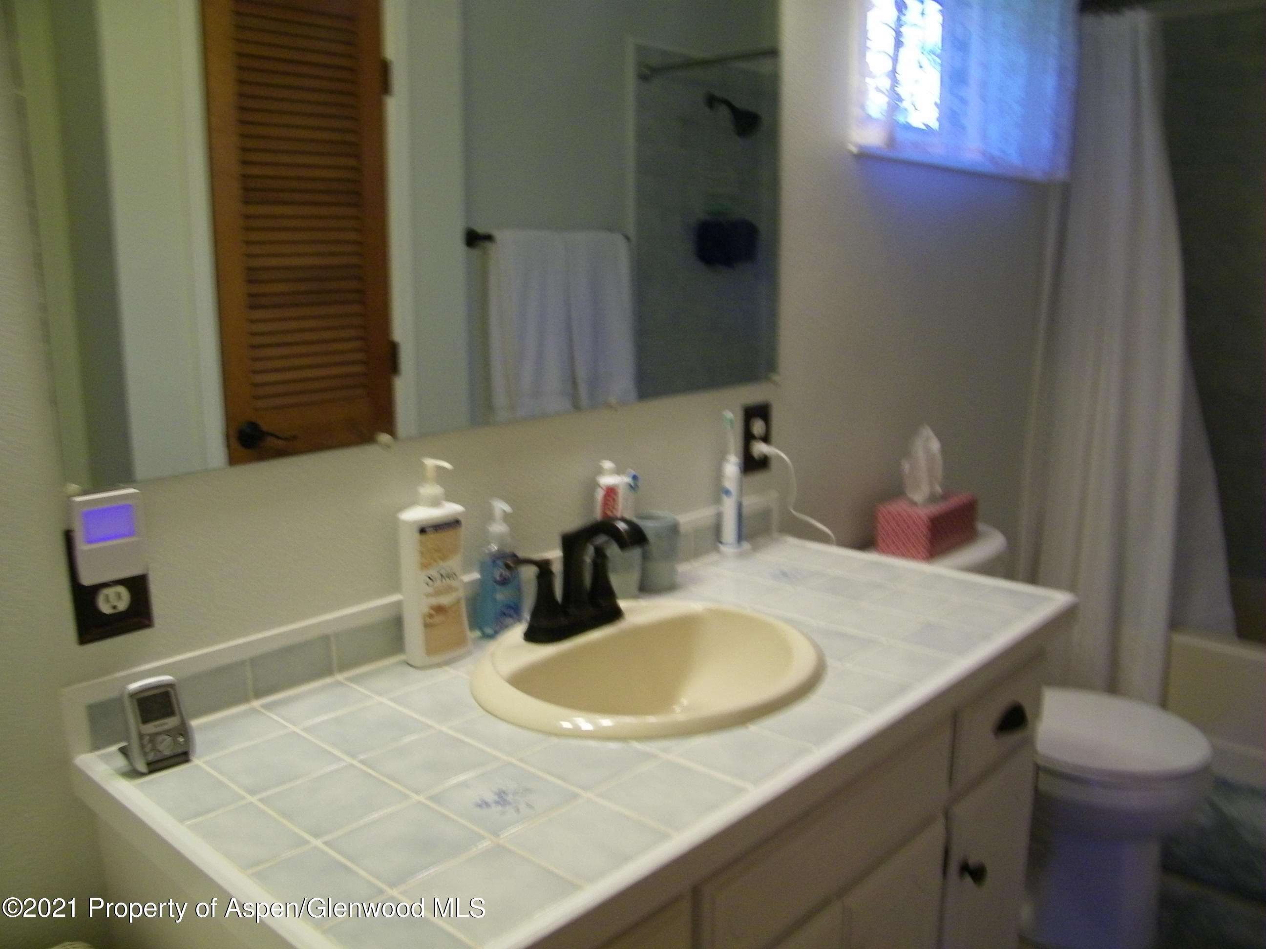 680 Moki Avenue Rifle, CO 81650 - Photo 32 of 39 a bathroom with a sink and a mirror