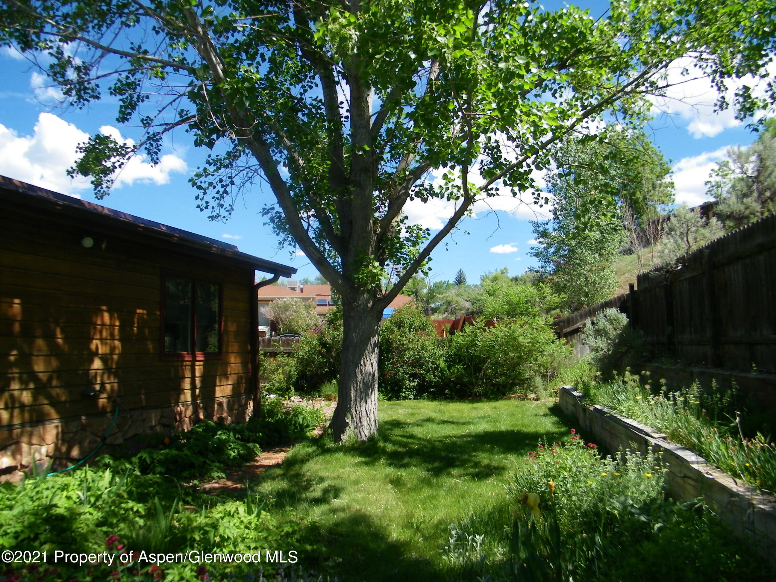 680 Moki Avenue Rifle, CO 81650 - Photo 33 of 39 a view of a house with a tree in a yard